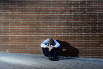 Fototapeta na wymiar businessman lost job lost sitting depressed on street ground