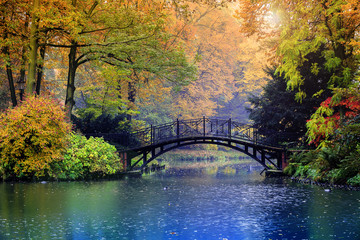 Autumn - Old bridge in autumn misty park