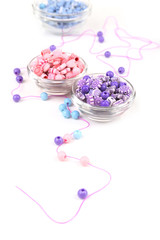Obraz na płótnie Canvas Beads in glass bowls isolated on white