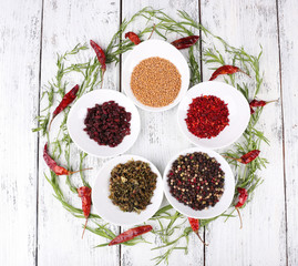 Spice with herbs and dried chilly pepper on wooden background