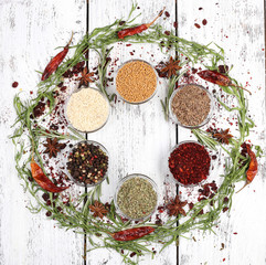 Spices in glass round bowls with herbs and chilly pepper