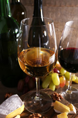 beautiful still life with wine, cheese and ripe grape