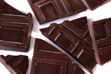 Cracked chocolate bar isolated on white