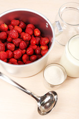 Cooking delicious strawberry jam in kitchen