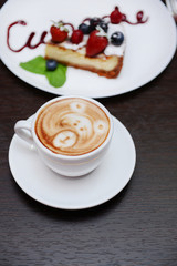 Cup of coffee with cute drawing in cafe