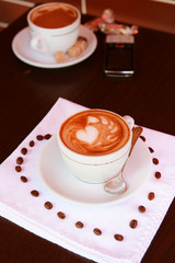 Cup of coffee with cute drawing in cafe