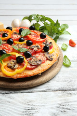 Delicious pizza served on wooden table