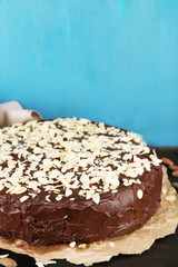 Tasty chocolate cake with almond, on old wooden table
