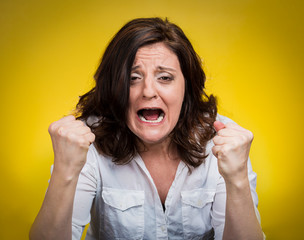 portrait young angry woman screaming on yellow background 