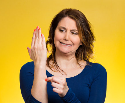 Woman pinches her skin Reality check hand gesture