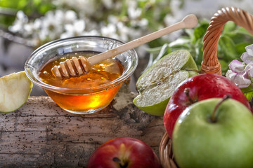 Domestic apples and honey on the natural rustic background