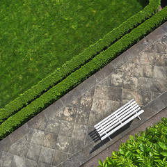 Geometric background with a white bench in a park. Top vie