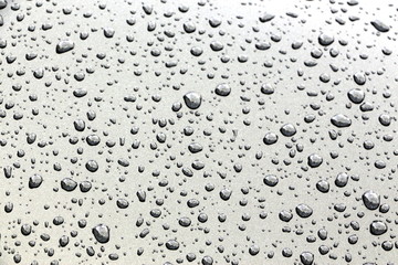 Water droplets on grey polished surface