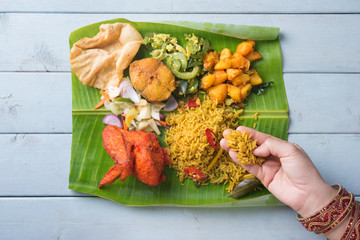 Indian woman eating biryani banana leaf rice