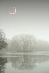eclipse of the sun in the autumn mist.