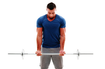 Muscular man doing exercises with barbell over white background