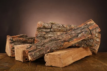 Fotobehang Brandhout textuur Heap of firewood on floor on dark background