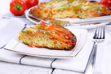 Casserole with vegetables on plate on table close-up