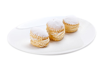 Cream cakes on a plate