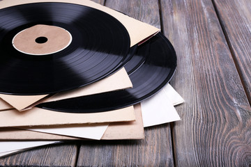 Fototapeta premium Vinyl records records and paper covers on wooden background