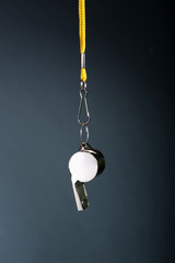 Sport metal whistle on color background