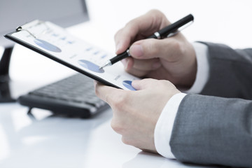 Businessman analyzing investment charts with computer. Accountin