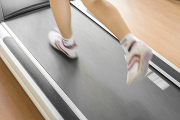 Closeup of woman running on treadmill