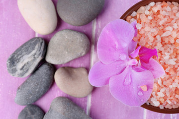Still life with beautiful blooming orchid flower, sea salt and