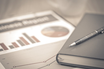 Business report. Cup of coffee and document.