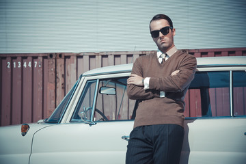 Retro fifties business fashion man with sunglasses leaning again