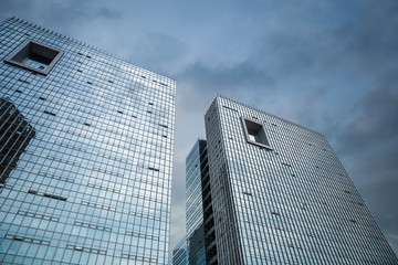 modern glass buildings in cloudy