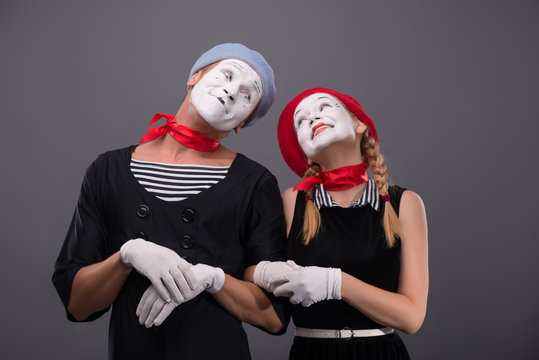 Portrait of funny mime couple with white faces and emotions isol
