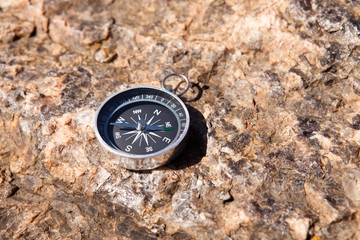 Fototapeta na wymiar Compass on a stone background