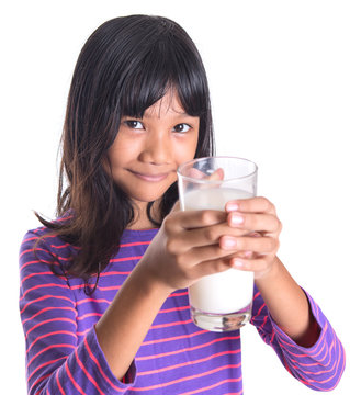 Young Asian preteen girl with a glass of milk