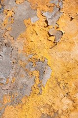Close Up of Yellow Peeling Paint on Cement Wall