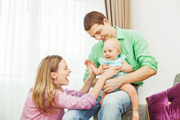 Family playing with the child together (focus on the eyes of bab