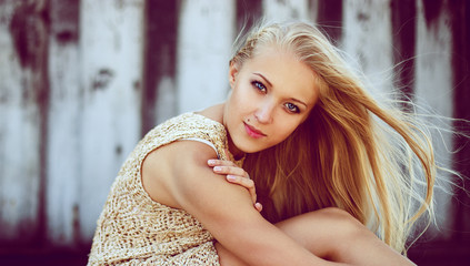 Naklejka premium Emotive portrait of young beautiful woman with long blonde hair