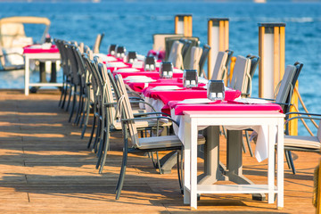 outdoor cafe located on the pier near the sea
