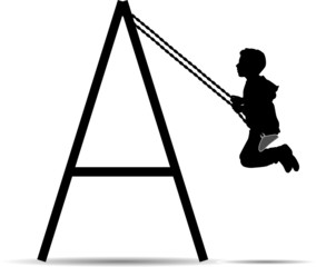 Boy swinging on a swing in the park