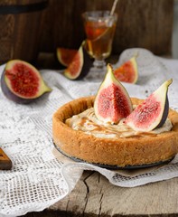 homemade tart with fresh figs on a vintage tablecloth