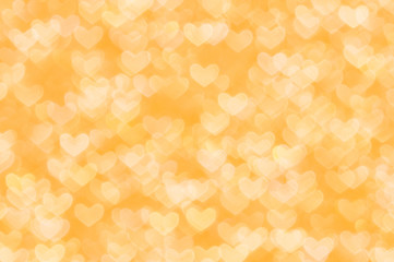 Fototapeta na wymiar defocused abstract orange hearts light background