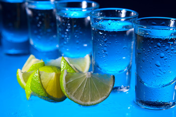 tequila and lime on glass table