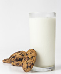 Milk glass  and cookies on white background