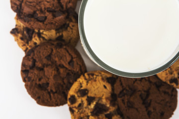 Milk glass  and cookies on white background