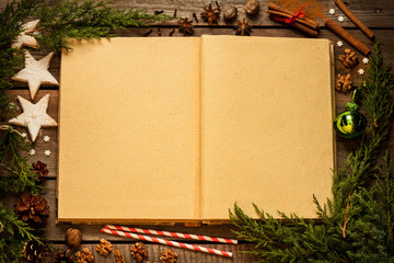 Old blank opened book with christmas decorations around