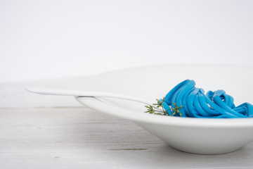 blue spaghetti, black place setting