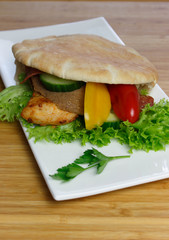 Pita bread with grilled chicken breast with lettuce and paprika