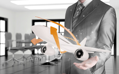 Businessman with airplane over his hand