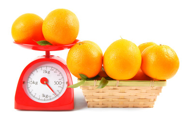 Oranges on scales and in a basket
