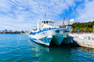 Fototapeta na wymiar Touristic catamaran at port of Málaga, Spain